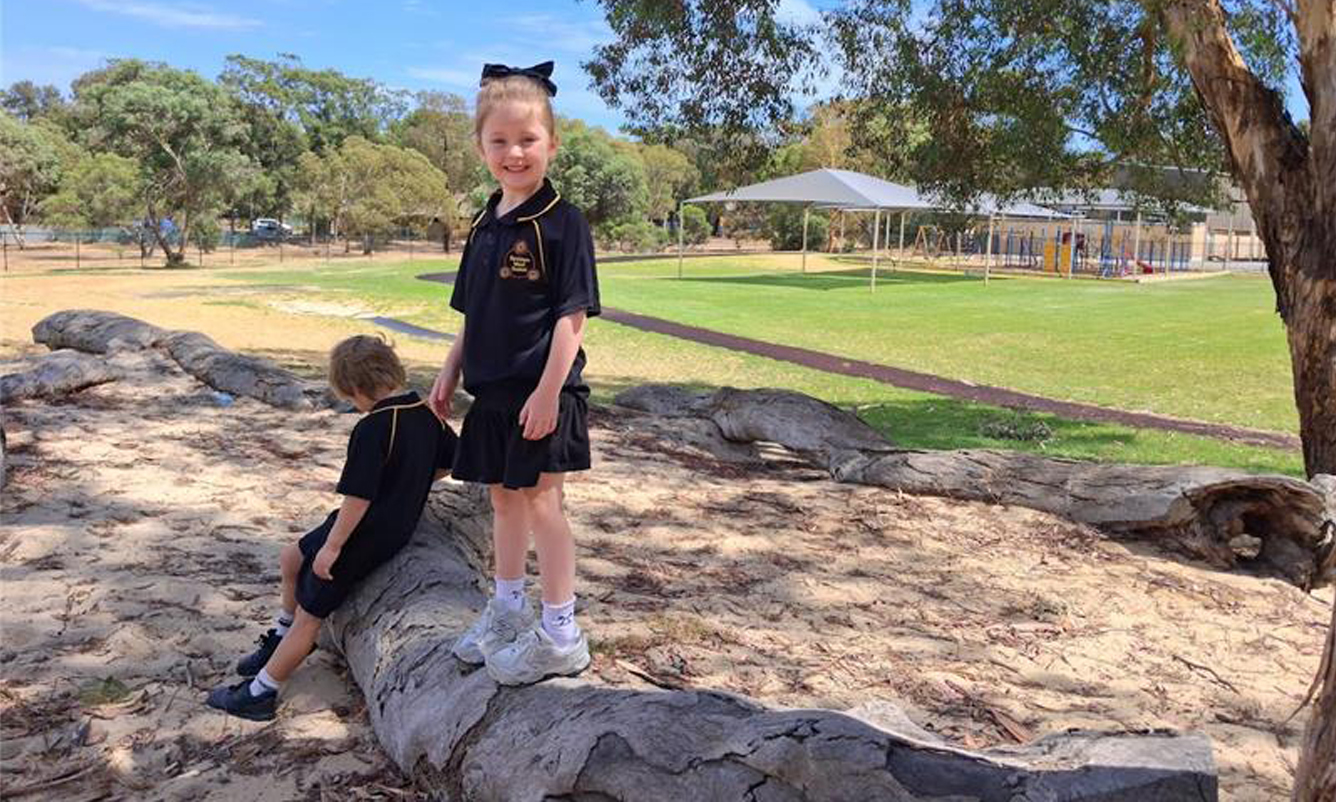 A student sitting on a beanbag reading a picture book